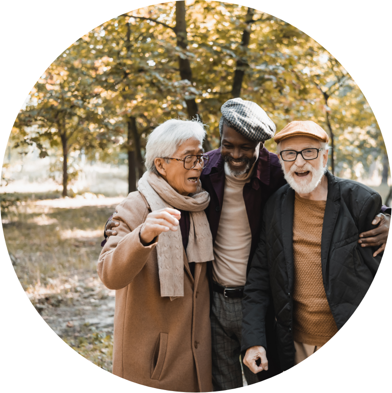 three senior males hugging each other and smiling while outside during the fall season