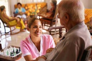 a nurse helps a senior in hospice care services at a personal care living community